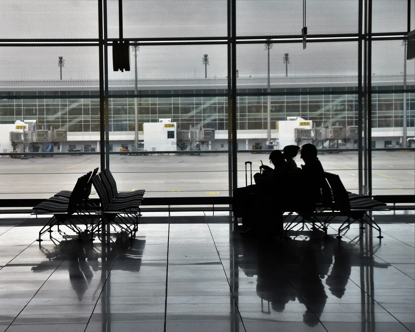 Travellers waiting at a boarding gate