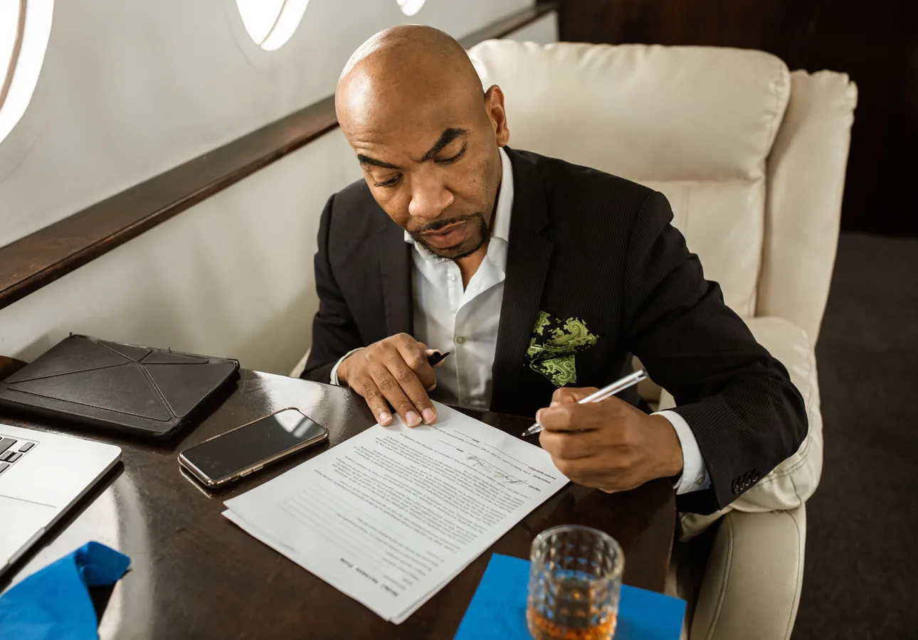 Business traveller reviewing documents in a business-class cabin