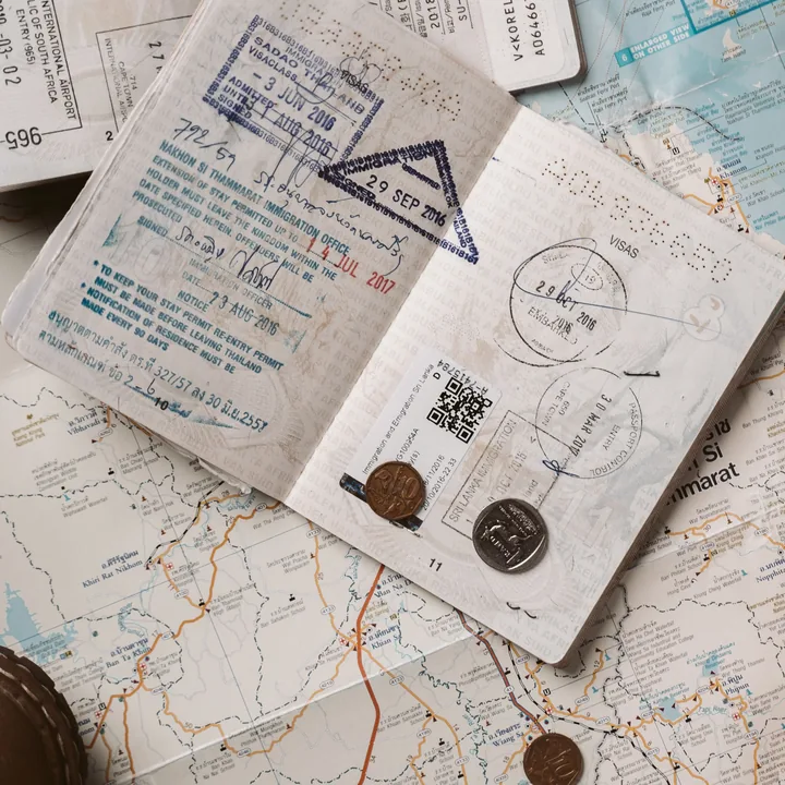 Stamped passport pages on a travel map
